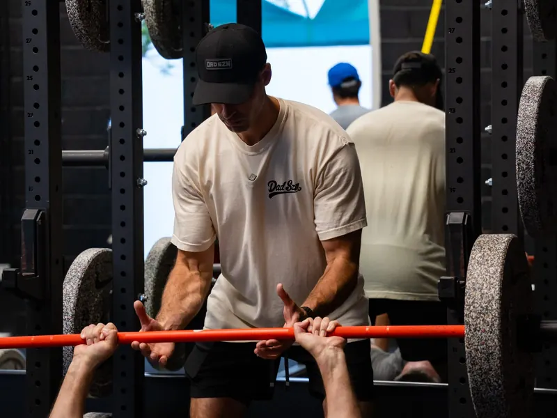 Pat O'Donnell coaching an athlete through a lift at the Sixteen Elite gym
